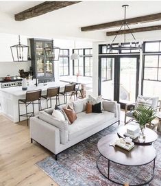 a living room filled with furniture and lots of windows