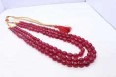 Name:  Ruby Quartz  Length:  18-20 Inch Width:  8x11 MM  Shape: Oval Beads Cut:    Smooth Quality : Good Quality Ruby Jewelry With Faceted Beads, Gold Ruby Beaded Necklace With Faceted Beads, Red Ruby Cut Beaded Necklaces, Elegant Ruby Gemstone Beads, Red Oval Gemstone Beads, Ruby Quartz, Natural Ruby, Quartz Necklace, Blue Opal