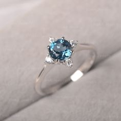 ◆The ring draws inspiration from the polaris. Hand-finished in Sterling sliver, this piece features a round shaped London Blue Topaz. Clear zirzons decorate around the main stone. An extremely simple celestial ring that you cannot miss. ◆ Production Description: Main stone Type: London Blue Topaz Main Stone Shape: Round Main Stone Size: 6*6mm Side stone: CZ Metal: 925 Sterling silver - Other options available in the drop down menu ◆ Customization: √Free for Add Engraving √Other Metal Type Availa Modern Blue Topaz Birthstone Ring, Modern Topaz Birthstone Ring, Modern Round Topaz Birthstone Ring, Celestial Style Sapphire Ring In White Gold, Celestial White Gold Sapphire Ring, Silver Minimalist Round Topaz Ring, Minimalist Silver Topaz Round Ring, Minimalist Silver Topaz Ring, Dreamy Rings