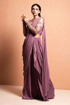 Mauve draped saree gown with floral hand embellished with 3D Silk yarn, crystals, pearls, glass beads and kasab thread work.
Component: 1
Embellished
Neckline: Round
Sleeve Length: Full
Fabric: Crepe
Color: Purple

Sheer back
Closure: Back zip - Aza Fashions Mauve Saree, Embellished Saree, Mauve Fabric, Bengali Culture, Saree With Belt, Asian Clothing, Draped Saree, Bridesmaid Attire, Desi Wear