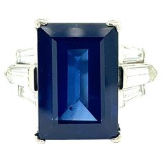 Sapphire Diamond Cocktail Ring Rectangular step-cut sapphire of 12.25 carats (16.01 x 10.94 x 6.41 mm), with four near-colorless tapered baguette diamonds and two modified kite step-cuts; mounted on platinum Size: 6.25 US Total weight: 11.7 grams Comes with GIA certificate no. 2231015890, dated July 25, 2023 Gia Certificate, Diamond Cocktail Ring, Baguette Diamonds, Diamond Cocktail Rings, July 25, Baguette Diamond, Sapphire Diamond, Cocktail Ring, Cocktail Rings