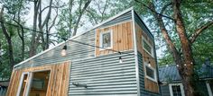 a tiny house in the woods surrounded by trees