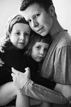 a man and two children hugging each other