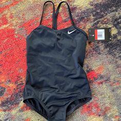 Classic Black Nike Swimsuit Girls Size Xs Recommended For Ages 6-8 New With Tags And Hygiene Safety Strip Black Stretch Swimwear For Play, Black Summer Beachwear Swimwear, Nike Black Sleeveless Swimwear, Nike Black Fitted Bodysuit, Nike Swimsuit, Nike Swim, Kids Swimming, Black Nike, Kids Nike