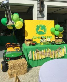 a green table topped with lots of food and balloons