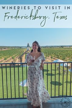 a woman standing in front of a fence with the words wineries to visit in fredericksburg, texas