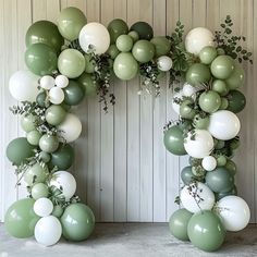 the letter o is made out of balloons and greenery