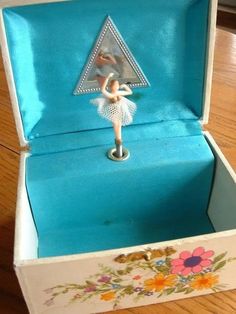 an open box with a figurine in it