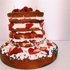 a cake with strawberries and whipped cream on top