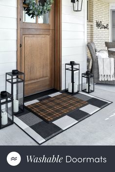 the front door is decorated with black and white checkered rugs, lanterns, and candles