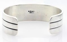 Experience Bruce Morgan's artistry with this handmade Stamped Silver Bracelet! It's the perfect addition to your jewelry collection and a welcome sight on any wrist! Measuring 5.25" tip to tip this bracelet will fit a wrist up to 6.75" in circumference. Weighs 55.5 grams +-. Modern Adjustable Cuff Bracelet For Collectors, Adjustable Modern Cuff Bracelet For Collectors, Silver Bracelets, Hand Stamped, Silver Bracelet, Jewelry Collection, Stamp, Bracelet, Silver