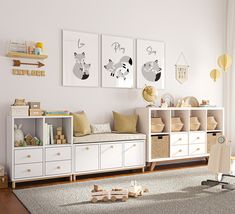 a child's room with white furniture and pictures on the wall