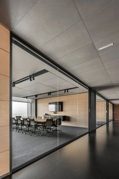 an empty conference room is reflected in the glass wall