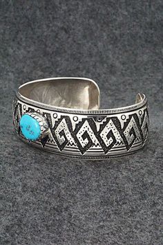 This beautiful turquoise and sterling silver bracelet was made by Navajo silversmith Richard Singer. The back is signed R Singer and stamped .925.Size: 6 7/8" (will fit up to a 8" wrist)Gap: 1 1/8"Width: 1"Free shipping on all orders! We ship with USPS and always include tracking. All orders ship within a day of payment.Returns are accepted up to 30 days after you receive your order. Just send us a message. Our shop offers cash back or store credit. The item must be returned in new condition. Traditional Engraved Turquoise Bracelets, Traditional Turquoise Engraved Bracelet, Southwestern Engraved Blue Cuff Bracelet, Southwestern Style Stamped Blue Bracelets, Southwestern Etched Turquoise Jewelry, Southwestern Style Etched Turquoise Jewelry, Southwestern Turquoise Etched Jewelry, Southwestern Sterling Silver Bracelet With Turquoise Inlay, Southwestern Blue Cuff Bracelet Stamped 925