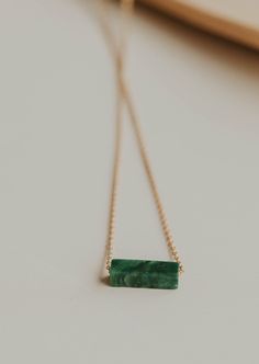 We’re in our Color Era and we’re vibing hard with these colorful stones right now. Gemma is a simple statement - one large stone strung on a delicate chain. 4x13mm stone is strung on a delicate cable chain. Chain measures 17". Our Moss stone is African Green Jade. Available in 14kt Gold Fill + Sterling Silver. Loving this stone? Check out our Moss Gemma Charms. Shop the entire Gemma Collection. Handmade in Eau Claire, WI. Our jewelry is handmade so each piece will be unique and may vary slightly Backdrops Necklace, Second Piercing, Colorful Stones, Zodiac Rings, Ear Party, Hoop Charms, Large Stone, Delicate Chain, Green Jade