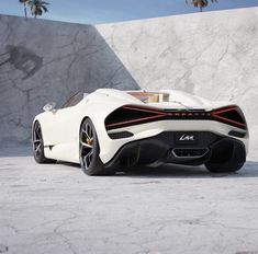 a white sports car parked in front of a concrete wall