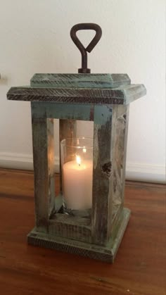 a small lantern with a lit candle inside