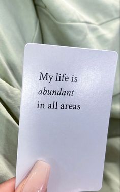 someone holding up a card that says, my life is abundant in all areas