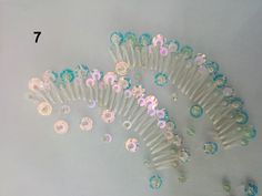 several pieces of plastic hair combs with flowers on them are arranged in a pattern