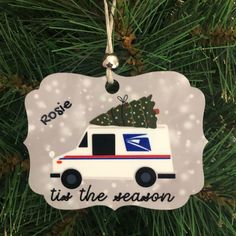 an ornament hanging from a christmas tree with the words tis the season written on it