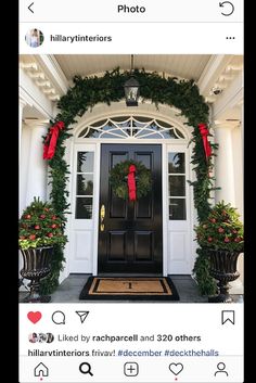 the front door is decorated for christmas with wreaths and red bows on it's doors