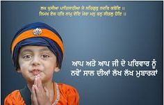 a young boy wearing an orange shirt and blue turban is making a funny face