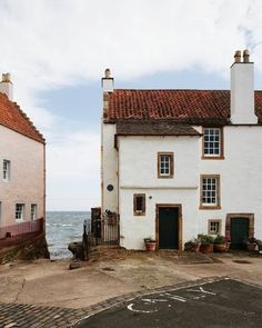 two white houses next to each other near the ocean