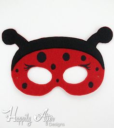 a ladybug mask with black dots on the eyes and nose is shown against a white background