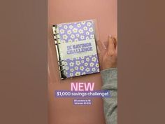 someone is holding up a book with the words savings challenge written on it in front of a pink background