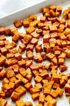 cooked sweet potatoes on a baking sheet ready to be baked