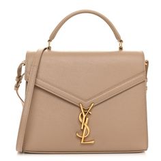 This is an authentic SAINT LAURENT Grain de Poudre Medium Classic Monogram Cassandra Top Handle in Dark Beige. This chic shoulder bag is crafted of grained beige calfskin leather. The bag features a rear patch pocket, gusseted side panels, a sturdy leather top handle, and an optional, adjustable shoulder strap with aged gold hardware. The envelope-style crossover flap opens with a matching aged gold YSL monogram press lock to a partitioned black leather interior with a patch pocket. Classic Monogram, Velvet Quilt, Envelope Bag, Dark Beige, Saint Laurent Bag, Black Cross Body Bag, Clothing Ideas, Side Panels, Medium Bags