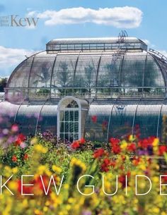 an image of a greenhouse with flowers in the foreground