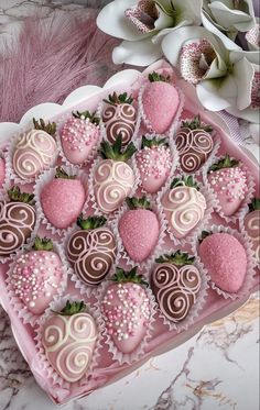 chocolate covered strawberries are arranged on a pink tray