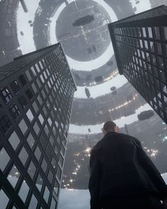 a man standing in the middle of two tall buildings