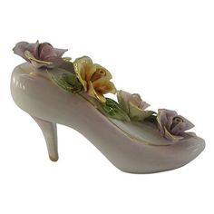 a ceramic shoe with flowers on it