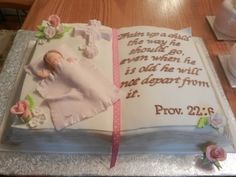 a cake that is decorated with an image of a baby in a blanket and flowers