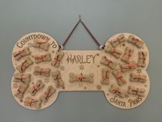 a wooden sign with dogs and name written on it that says,'harley santa paws '