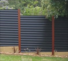 a black fence with wooden slats on it