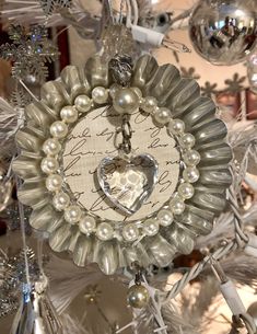 an ornament with a heart in the center surrounded by ornaments