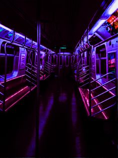 the inside of a subway car with purple lights and railings on both sides,