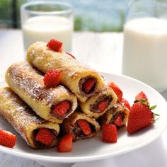 there are many different desserts on the plate and one is filled with strawberries