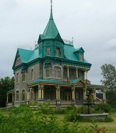 an old victorian style house with a green roof