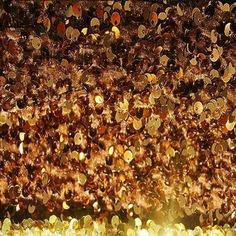 many gold coins are falling down from the ceiling and onto the ground in this artistic photo