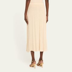 Zimmermann "Halliday" ribbed-knit midi skirt  High rise Elastic waistband A-line silhouette Hem falls below the knee Pull-on style Viscose/nylon/polyamide/metallic fibers Hand wash or dry clean Imported Elegant Ribbed Skirt For Summer, Spring Midi Ribbed Skirt, Luxury Bohemian Midi Skirt, Ribbed Stretch Midi Skirt, Luxury Linen Midi Skirt, Elegant Beige Ribbed Skirt, Relaxed Ribbed Midi Skirt, Luxury Midi-length Flowy Skirt, Luxury Lace Trim Midi Skirt