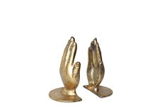 two gold colored metal hand sculptures sitting on top of each other