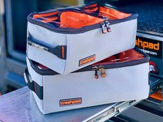 two cooler bags sitting on top of each other