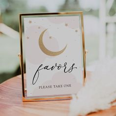 a sign that says favors on it sitting on top of a wooden table