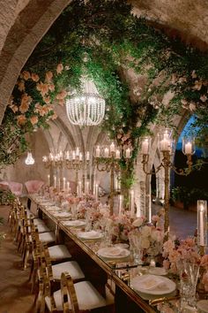 a long table set up with flowers and candles for an elegant wedding reception at the palace