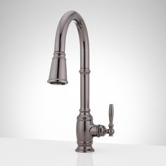 a kitchen faucet with two handles and nozzles on the side, against a white background