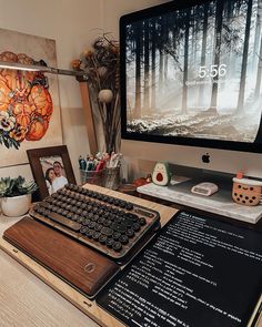 a desk with a keyboard, mouse and pictures on the wall behind it in front of a computer monitor